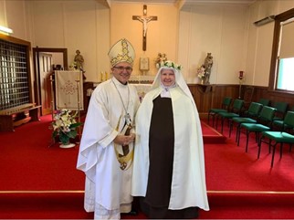 Sr Lauren of the Cross receiving her habit on 15 October, standing next to Bishop Michael Gielen of Christchurch.