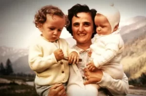 St Gianna Beretta Molla carrying two of her young children.